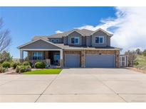 Charming two-story home with stone accents, gray siding, and a spacious two-car garage at 2339 Elkhorn St, Parker, CO 80138