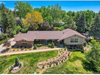 Stunning home with lush landscaping, mature trees, and a well-maintained lawn at 4000 S Dahlia St, Cherry Hills Village, CO 80113