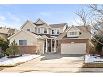 Charming two-story home featuring brick accents, an attached two-car garage, and a well-maintained front yard at 16650 E Timberwolf Ln, Parker, CO 80134