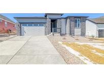 Charming exterior showing stone accents, a concrete driveway, and a two-car garage at 39555 Gwinett Cir, Elizabeth, CO 80107