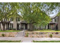 Charming home with a stone front garden, well manicured lawn and steps to the covered entryway at 216 N Monroe St, Denver, CO 80206