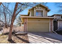 Charming two-story home featuring a well-kept lawn, two-car garage, and inviting entrance at 2192 E Phillips Ln, Centennial, CO 80122