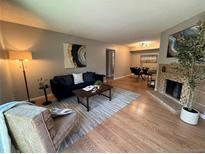 Comfortable living room featuring a fireplace and hardwood floors at 3550 S Harlan St # 259, Denver, CO 80235