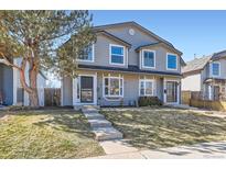 Charming two-story home with a well-maintained lawn and inviting front entrance on a sunny day at 2163 S Grant St, Denver, CO 80210