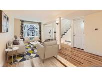 Inviting living room with hardwood floors, comfortable seating, and large window showcasing the exterior view at 2163 S Grant St, Denver, CO 80210