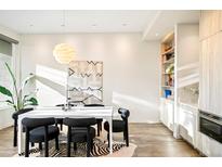 Bright dining room features a modern table, stylish chairs, zebra-print rug, and contemporary light fixture at 2659 S Cherokee St, Denver, CO 80223