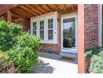 Inviting front entrance with brick facade, white trim, and a welcoming doormat at 1172 S Zeno Way # F, Aurora, CO 80017