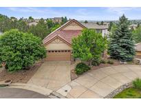 Charming home with lush landscaping, a driveway, and a two-car garage at 6542 S Tempe St, Aurora, CO 80016