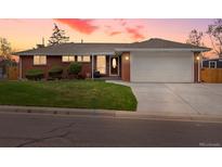 Charming brick home featuring a well-maintained lawn and an attached two-car garage at 2698 E Cresthill Ave, Centennial, CO 80121