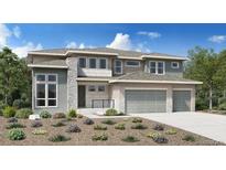 Charming two-story home with stone accents, gray siding, a well-kept yard, and a three car attached garage at 3768 Backslope Ln, Castle Rock, CO 80108