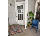 Cozy front entrance features a white door, blue chair, and decorative rug at 7481 Singing Hills Dr, Boulder, CO 80301