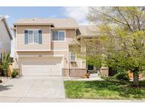 Beautiful home featuring a well-manicured lawn, a two-car garage, and mature trees at 9469 W Ute Dr, Littleton, CO 80128