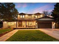 Stunning two-story home with a well-manicured lawn, inviting entrance, and attached garage at 5810 S Galena St, Greenwood Village, CO 80111