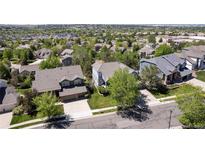 An aerial view shows several well-maintained homes surrounded by mature trees in a quiet, suburban neighborhood at 20234 E Lake Cir, Centennial, CO 80016