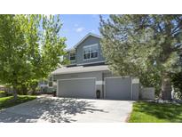 Charming two-story home featuring a three-car garage and lush landscaping at 20234 E Lake Cir, Centennial, CO 80016