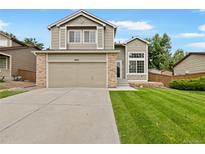 Two-story house with attached garage and well-manicured lawn at 9431 Cove Creek Dr, Highlands Ranch, CO 80129