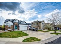 Charming two-story home featuring a well-manicured lawn and a driveway with ample parking space at 11699 Pink Phlox Dr, Parker, CO 80134