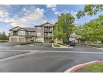 Inviting condo building with well-maintained landscaping and ample parking on a beautiful day at 7418 S Quail Cir, Littleton, CO 80127