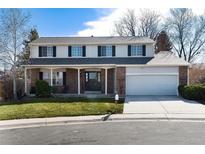 Charming two-story home with brick accents, attached garage, and well-maintained front yard at 1494 S Yampa Ct, Aurora, CO 80017