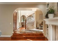 Elegant entryway with hardwood floors and curved staircase at 4 Orchard Ln, Greenwood Village, CO 80121