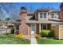 Charming townhome with brick chimney, landscaping, and welcoming entryway at 14271 E Dickinson Dr # F, Aurora, CO 80014