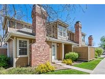 Charming two-story home with a well-maintained yard, brick chimney, and inviting entrance at 14271 E Dickinson Dr # F, Aurora, CO 80014