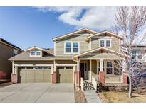 Charming two-story home features a three-car garage, a covered porch, and well-maintained landscaping at 19503 W 58Th Pl, Golden, CO 80403