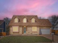 Charming two-story brick home with a manicured lawn and an attached garage, perfect for suburban living at 3873 W 98Th Ave, Westminster, CO 80031