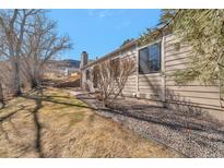 Tan siding home with rock landscaping, bare trees, and views of the land at 18258 W 58Th Pl # 1, Golden, CO 80403