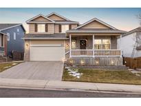 Two-story house with a large front yard, attached garage, and covered porch at 13735 Steele Ct, Thornton, CO 80602