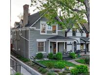 Charming gray two-story home with a covered front porch and well-maintained landscaping at 1729 N Clarkson St, Denver, CO 80218