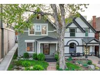 Charming two-story home featuring a well-manicured front yard and inviting front porch with craftsman details at 1729 N Clarkson St, Denver, CO 80218
