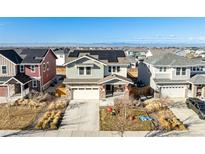 Two-story house with solar panels, mountain views, and landscaped yard at 5957 N Orleans St, Aurora, CO 80019