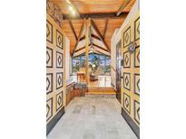 Inviting entryway with vaulted wood ceilings and large windows offering scenic views at 994 Timber Ln, Boulder, CO 80304
