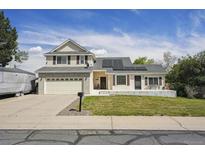 Charming two-story home with a manicured lawn and a two-car attached garage at 9908 Garfield Ct, Thornton, CO 80229
