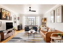 Bright living room with large window, modern furniture, and stylish decor at 1060 N Washington St # 301, Denver, CO 80203