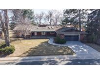 Charming brick home featuring an attached garage and a well-maintained front yard with mature trees at 178 E 11Th Ave, Broomfield, CO 80020