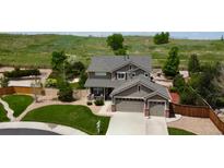 Charming two-story home features a spacious two car garage and beautiful landscaping with a fenced backyard at 11895 Hitching Post Ct, Parker, CO 80134