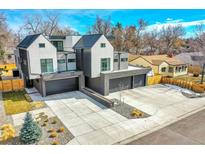 Modern home featuring a spacious driveway, two garages, and a contemporary architectural design at 3910 Reed St, Wheat Ridge, CO 80033