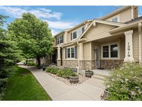 Charming townhome with stone accents, well-maintained landscaping, and inviting walkway at 12919 W Burgundy Dr, Littleton, CO 80127