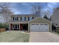 Inviting two-story home featuring a well-maintained lawn, attached garage and dormer windows at 6719 E Costilla Cir, Centennial, CO 80112