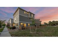 Charming two-story home with landscaped yard and a modern exterior paint scheme at 10200 Xanadu St, Commerce City, CO 80022