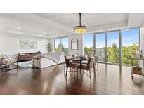 Bright, open-concept living and dining space featuring hardwood floors and panoramic views at 1900 E Girard Pl # 505, Englewood, CO 80113