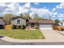 Charming ranch-style home with a well-manicured lawn and attached two-car garage at 2399 E 99Th Way, Thornton, CO 80229