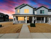 Charming two-story home featuring stone accents, white siding, and a welcoming front porch at 6531 N Malaya St, Aurora, CO 80019