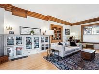 Cozy living room with hardwood floors, built-in shelving, and abundant natural light at 1401 N Franklin St # 1, Denver, CO 80218