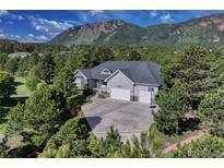 Stunning home featuring a three-car garage, large driveway, and mountain views at 18376 Heavens Pl, Monument, CO 80132