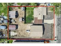Aerial view of a property with a fenced yard, several outbuildings, and a detached garage at 4835 Harlan St, Wheat Ridge, CO 80033