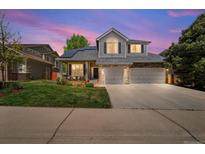 Charming two-story home featuring a stone facade, well-manicured lawn, and a spacious two-car garage at 2019 Clipper Dr, Lafayette, CO 80026