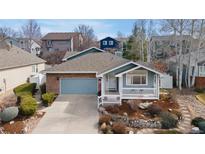 Charming single-Gathering home with brick and siding, featuring a front porch and well-maintained landscaping at 742 Megan Ct, Longmont, CO 80504